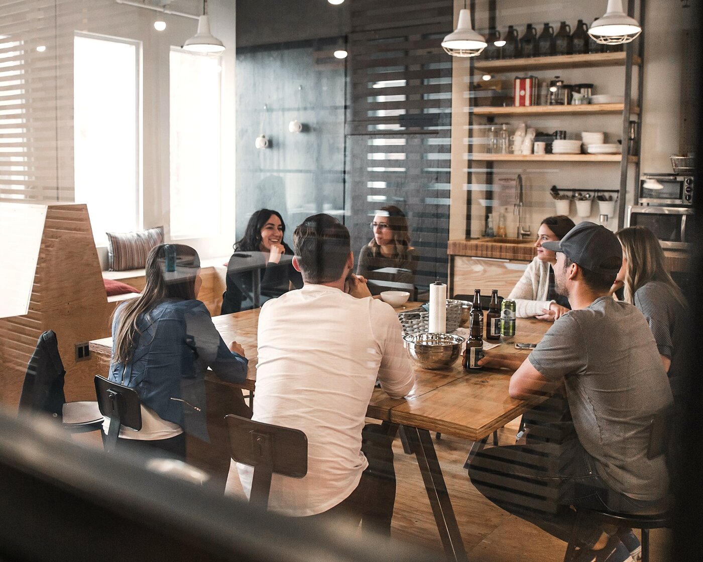 Team meeting around a wood table in natural light