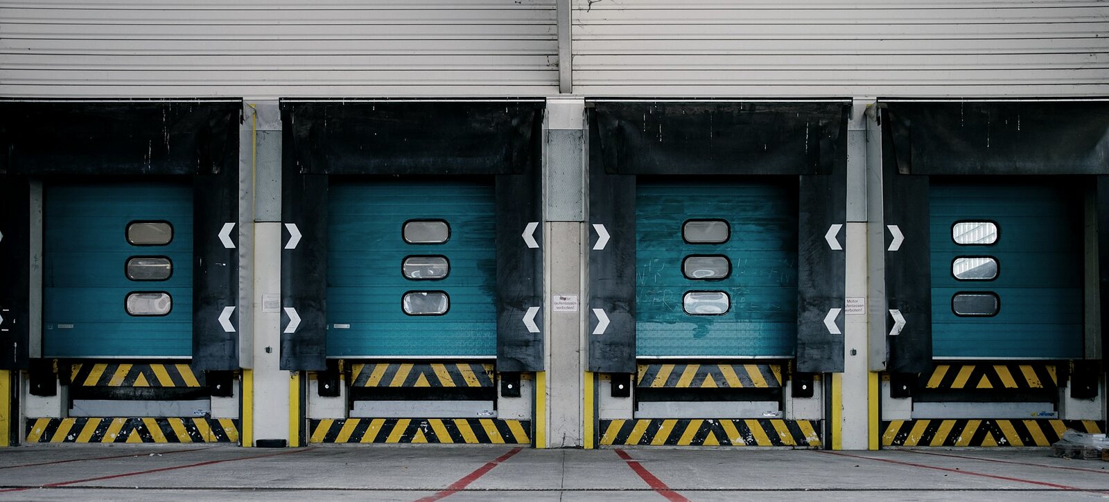 Row of loading dock doors at a light industrial building