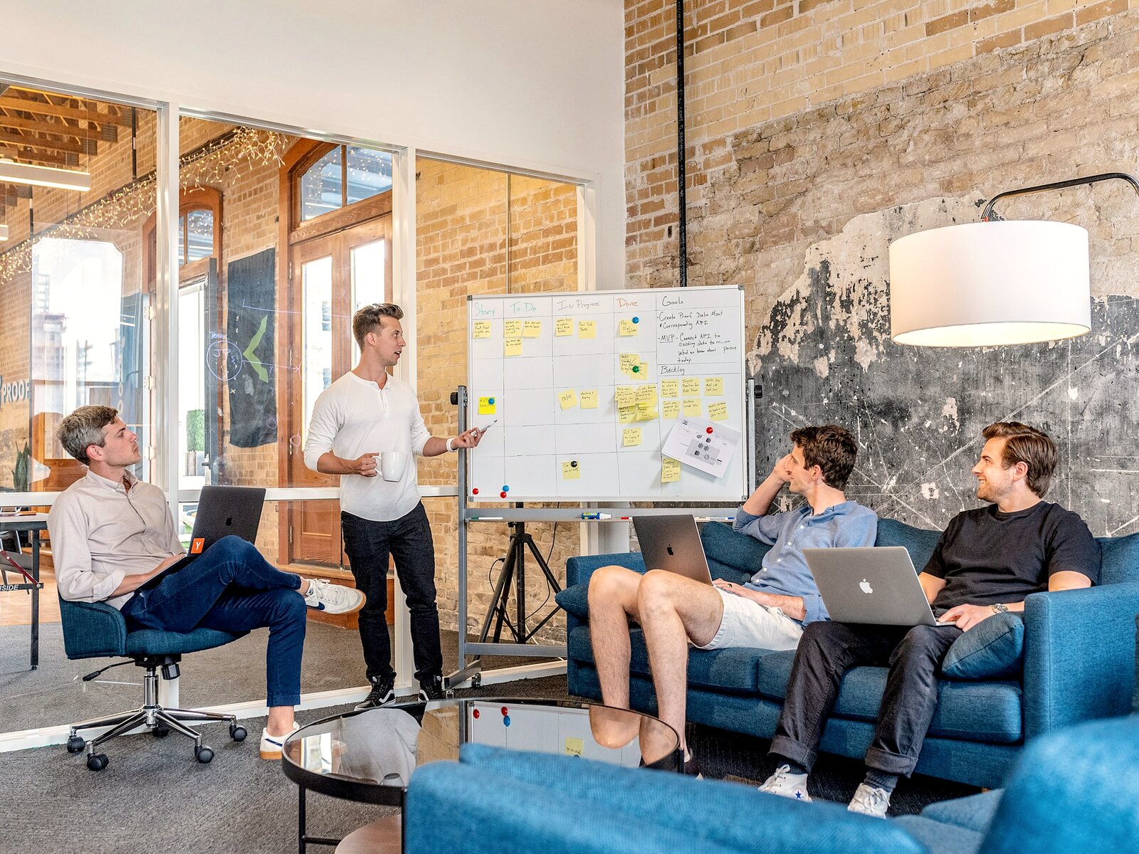 Start-up team discussing plans at a whiteboard